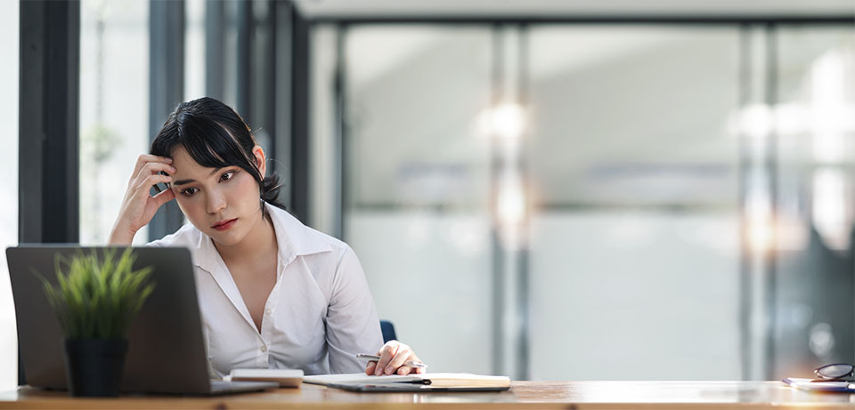 woman with Long COVID confused sitting at computer