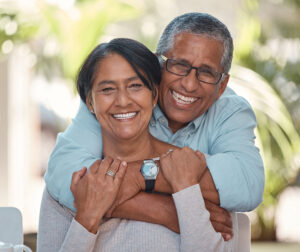 Portrait, elderly and couple bonding on a patio at home