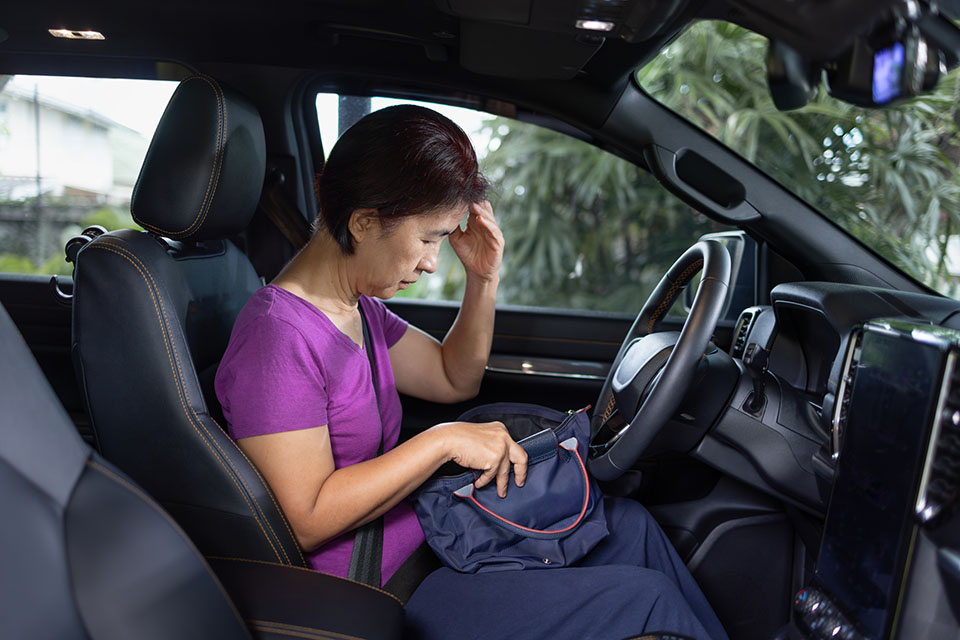 woman with memory loss sitting in car and can't find her keys