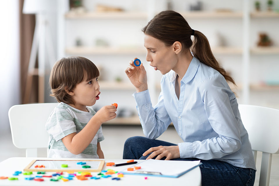 Child doing ABA with therapist